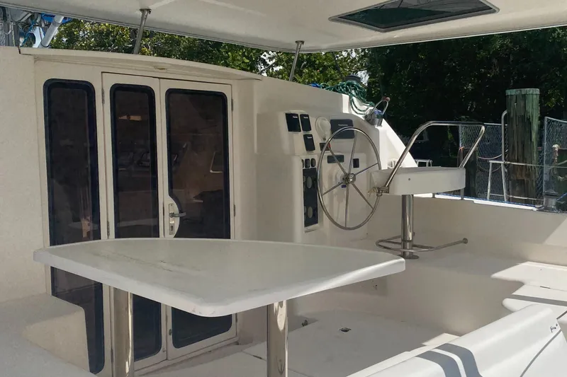 Slide: The Image of 2003 Leopard 38 yacht cockpit with steering wheel and seating area. - 7