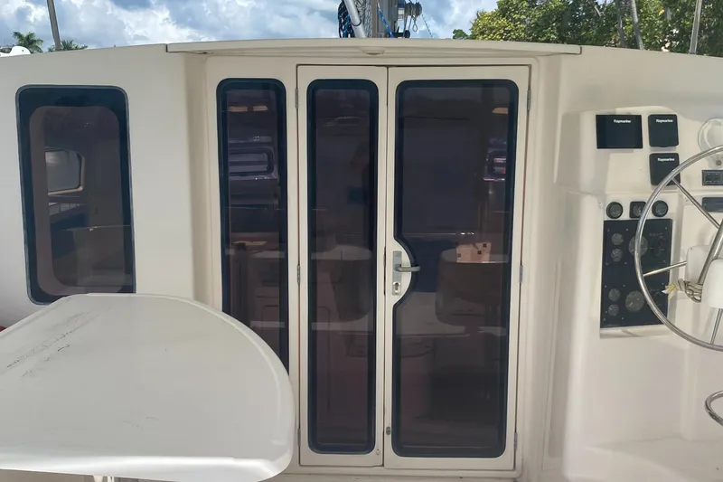 Slide: The Image of 2003 Leopard 38 yacht cockpit with glass doors and steering wheel. - 8