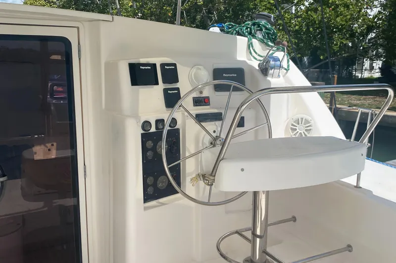 Slide: The Image of Steering wheel and controls of a 2003 Leopard 38 catamaran yacht. - 9