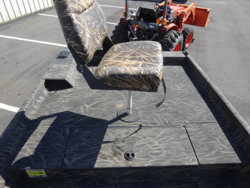 Slide: The Image of 2020 Alweld 1752 Marsh Console boat with camo seating and tractor in background. - 12