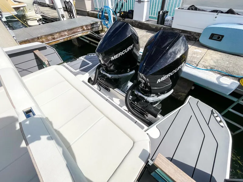 Slide: The Image of 2024 Saxdor 320 GTO with dual Mercury outboard engines at a dock. - 10
