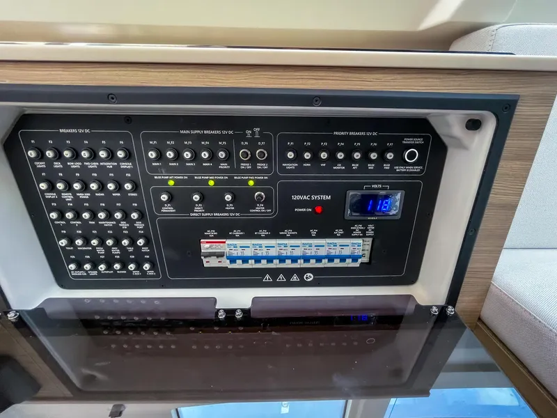 Slide: The Image of Control panel of 2024 Saxdor 320 GTO boat, featuring switches and electrical system indicators. - 15