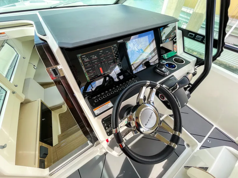 Slide: The Image of 2024 Saxdor 320 GTO helm with modern navigation displays and sleek steering wheel design. - 4