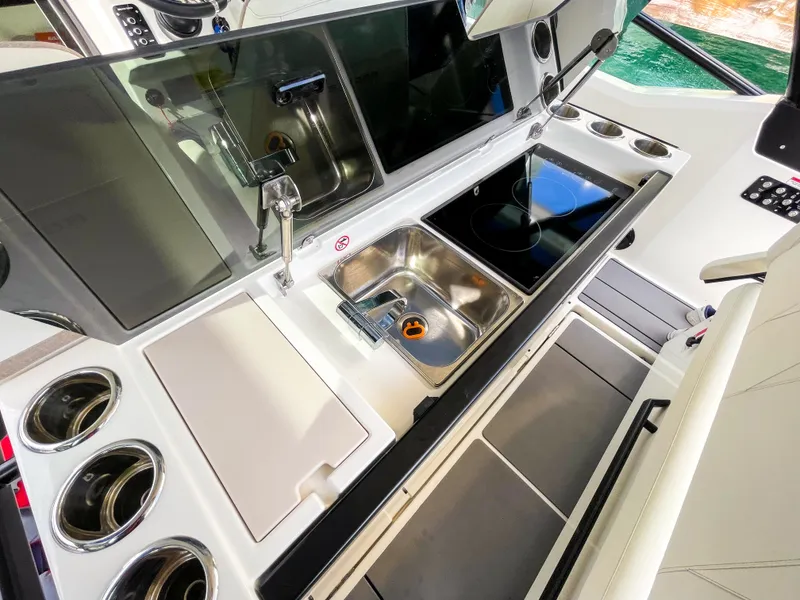 Slide: The Image of 2024 Saxdor 320 GTO yacht kitchen with sink, stove, and modern amenities. - 8