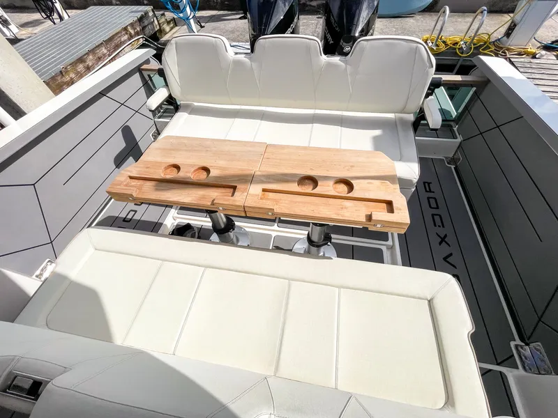 Slide: The Image of 2024 Saxdor 320 GTO boat interior with white seating and wooden table. - 9