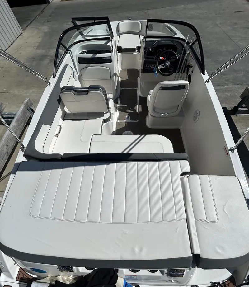 Slide: The Image of 2017 Bayliner VR5 boat interior with white seating and steering console. - 3
