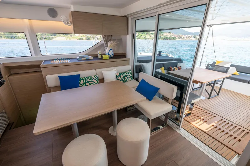 Slide: The Image of Luxurious interior of 2025 Lagoon 43 yacht with modern dining area and scenic water views. - 24