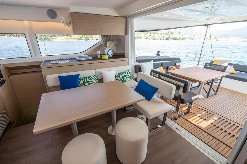 Slide: The Image of Luxurious interior of 2025 Lagoon 43 yacht with modern dining area and scenic ocean view. - 25