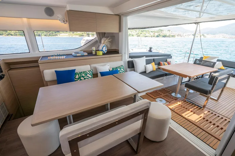 Slide: The Image of Luxurious interior of 2025 Lagoon 43 yacht with modern dining area and scenic ocean view. - 27