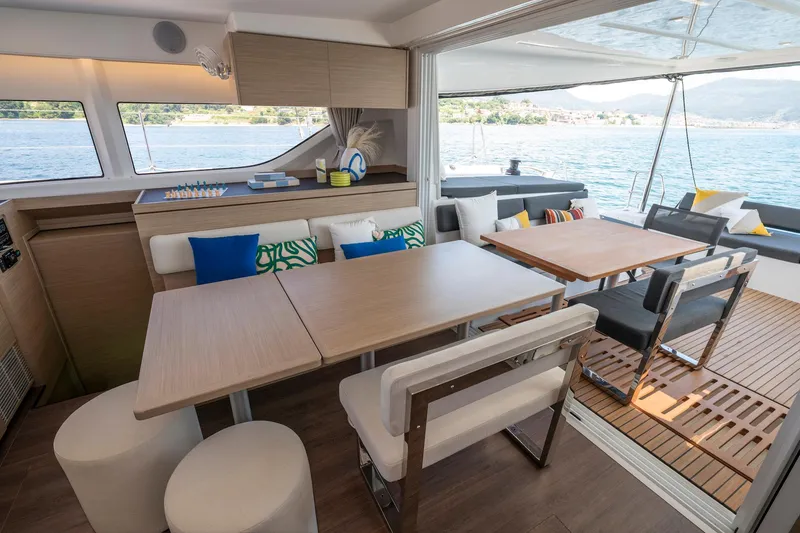 Slide: The Image of Luxurious interior of 2025 Lagoon 43 yacht with modern dining area and scenic ocean view. - 30