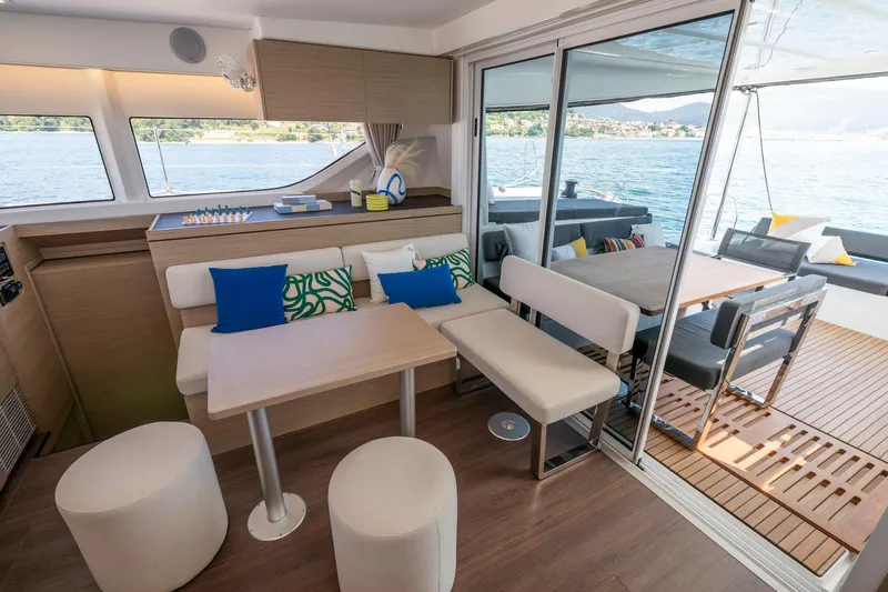 Slide: The Image of Interior of 2025 Lagoon 43 yacht with modern seating and dining area by the water. - 32