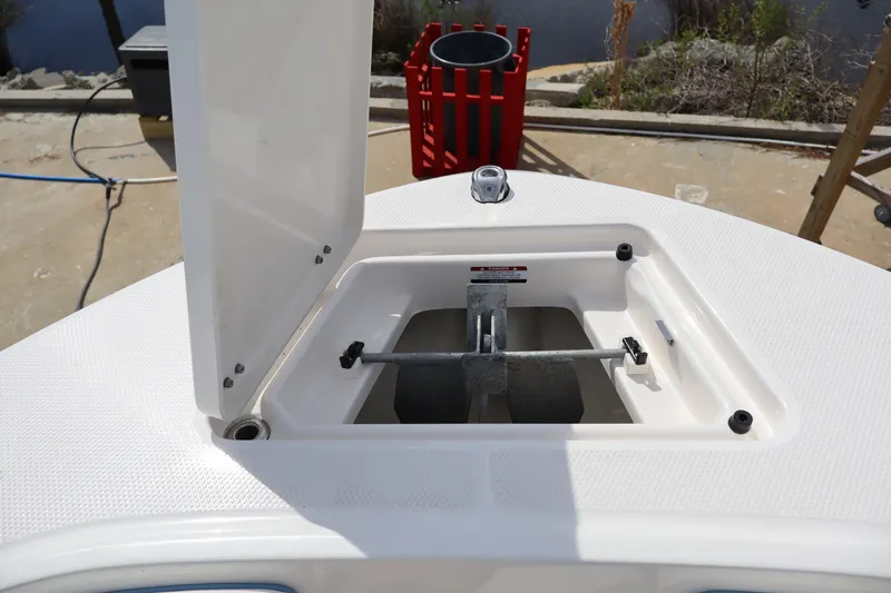 Slide: The Image of 2023 Robalo R200 Center Console anchor storage compartment open on deck. - 13