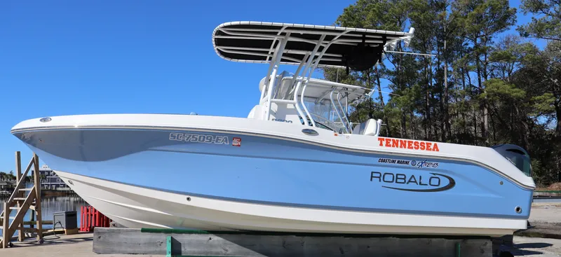 Slide: The Image of 2023 Robalo R200 Center Console boat on display, featuring sleek design and blue hull. - 3