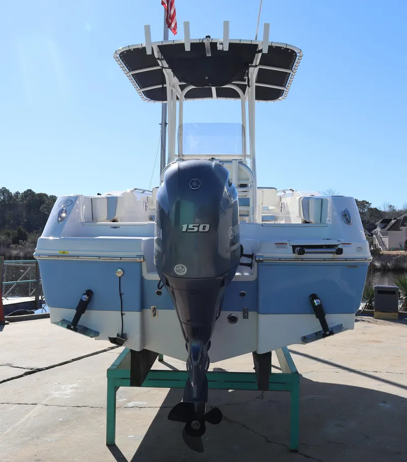 Slide: The Image of 2023 Robalo R200 Center Console boat with outboard motor, docked on a stand. - 4