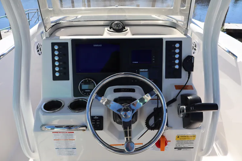 Slide: The Image of 2023 Robalo R200 Center Console boat dashboard with steering wheel and navigation controls. - 5