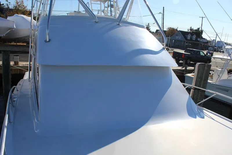 Slide: The Image of 2005 Hatteras 50' Convertible yacht docked, showcasing sleek design and structure. - 11