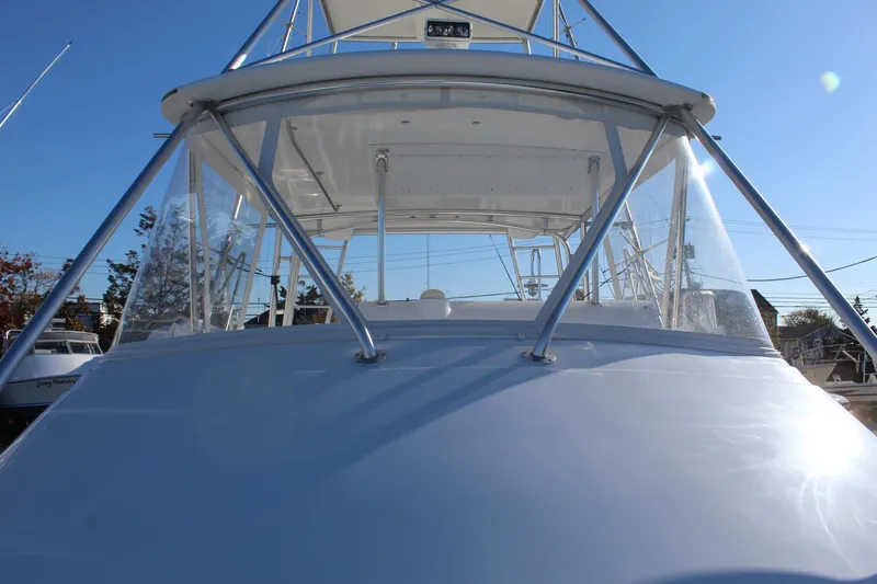 Slide: The Image of 2005 Hatteras 50' Convertible yacht, front view with clear skies. - 12