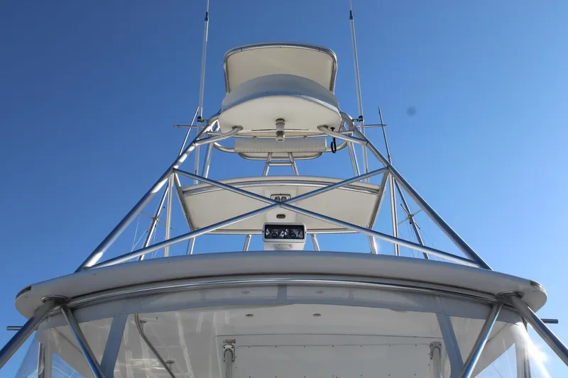 Slide: The Image of 2005 Hatteras 50' Convertible yacht tower against clear blue sky. - 13