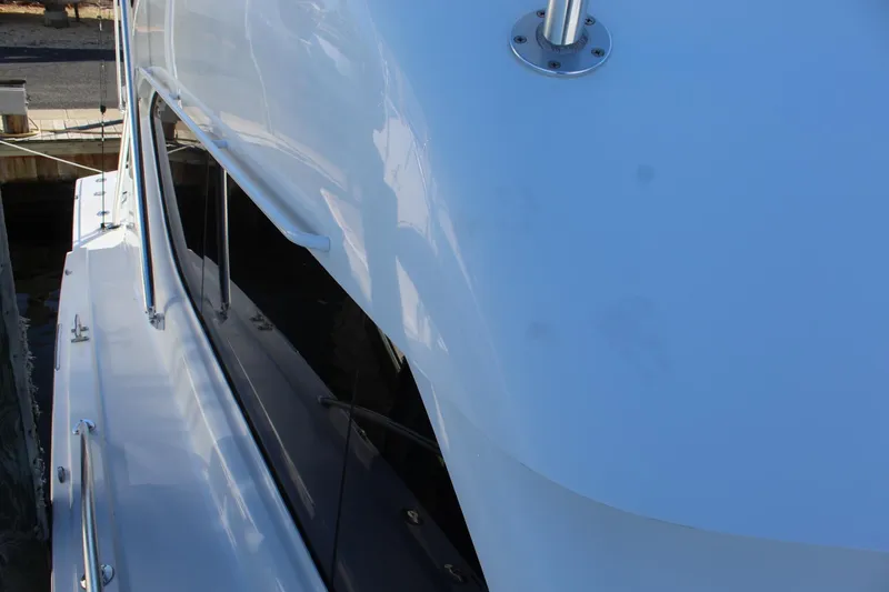 Slide: The Image of Side view of a 2005 Hatteras 50' Convertible yacht docked at a marina. - 16