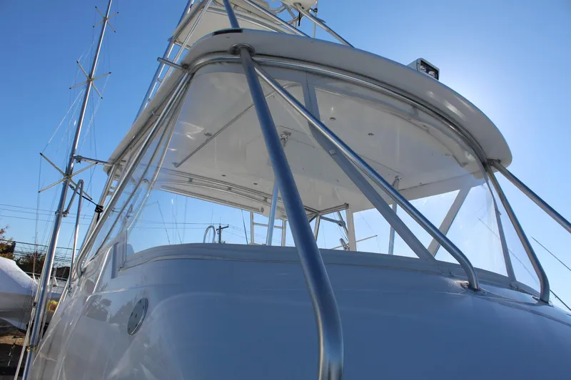 Slide: The Image of 2005 Hatteras 50' Convertible yacht, sleek design, viewed from below against clear blue sky. - 17