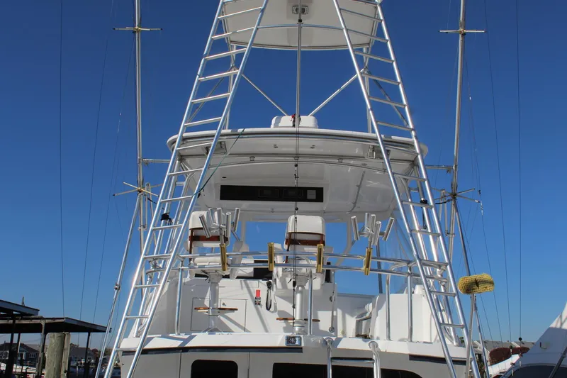 Slide: The Image of 2005 Hatteras 50' Convertible yacht with tower against clear blue sky. - 18