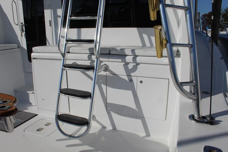 Slide: The Image of Ladder and seating area on 2005 Hatteras 50' Convertible yacht deck. - 22