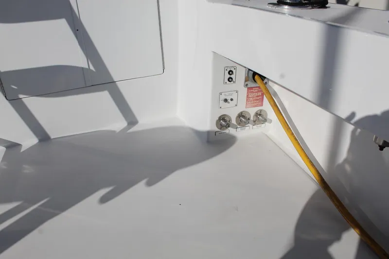 Slide: The Image of 2005 Hatteras 50' Convertible yacht electrical connections with yellow power cable. - 23