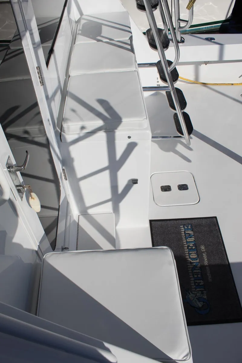 Slide: The Image of 2005 Hatteras 50' Convertible yacht deck with seating and ladder. - 25