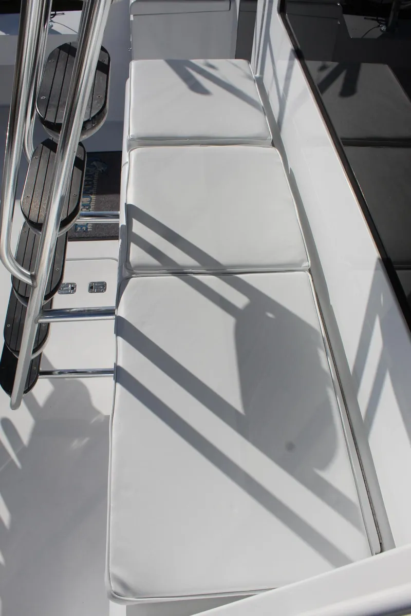 Slide: The Image of White cushioned seating on 2005 Hatteras 50' Convertible yacht deck. - 26