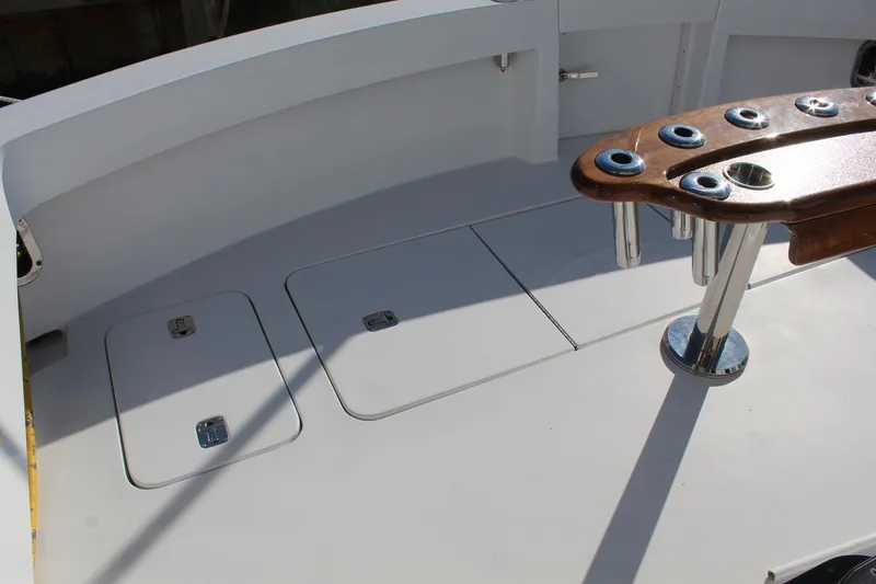 Slide: The Image of Deck of 2005 Hatteras 50' Convertible yacht with rod holders and storage hatches. - 27