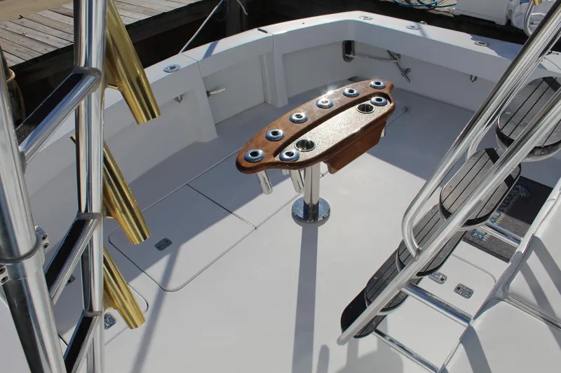 Slide: The Image of 2005 Hatteras 50' Convertible yacht deck with fishing rod holders and ladder. - 30