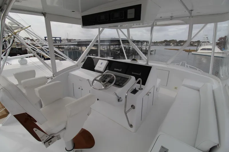 Slide: The Image of Helm of 2005 Hatteras 50' Convertible yacht with modern navigation equipment. - 34