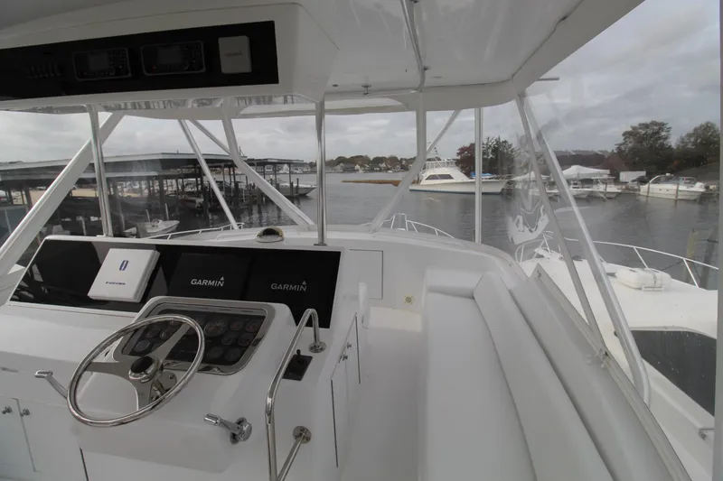 Slide: The Image of 2005 Hatteras 50' Convertible yacht helm with Garmin navigation, docked in marina. - 39