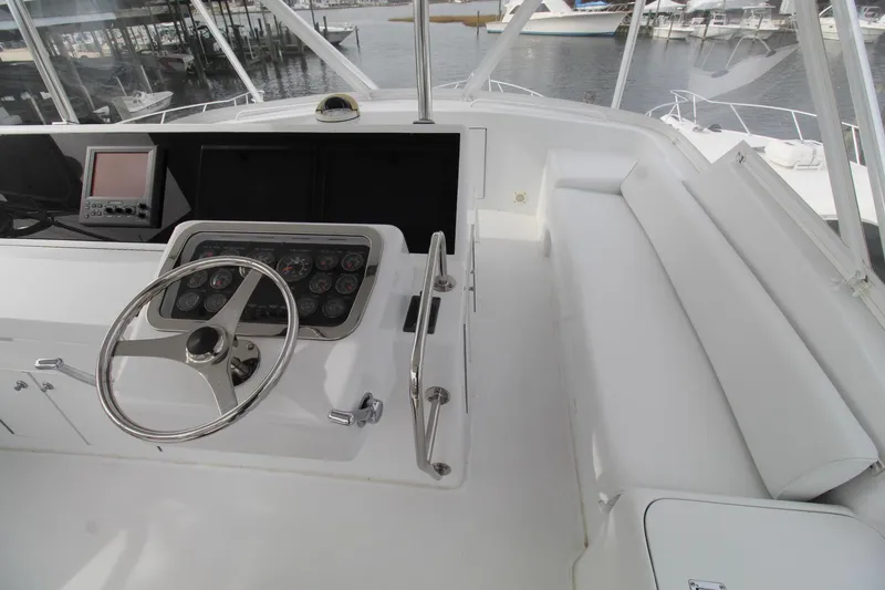 Slide: The Image of Helm of 2005 Hatteras 50' Convertible yacht with steering wheel and gauges. - 40