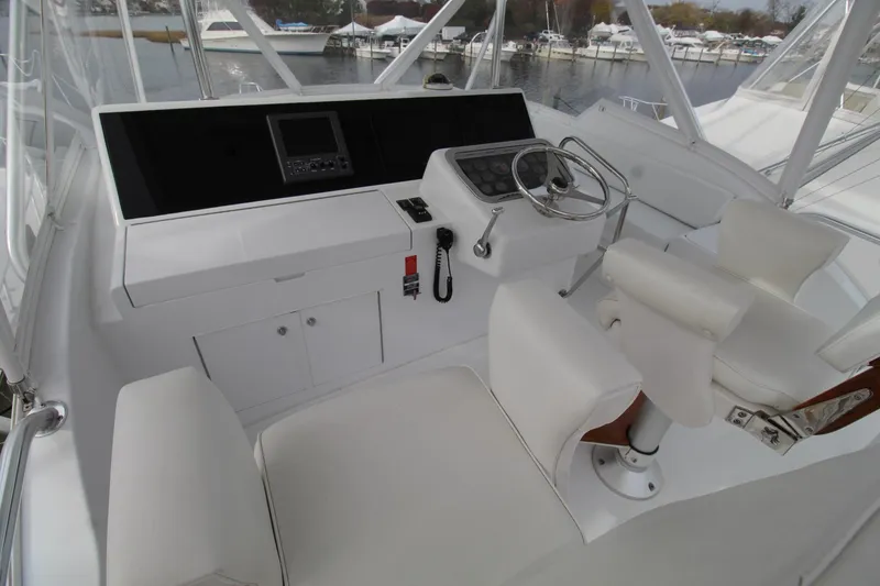 Slide: The Image of 2005 Hatteras 50' Convertible yacht helm with steering wheel and navigation equipment. - 43