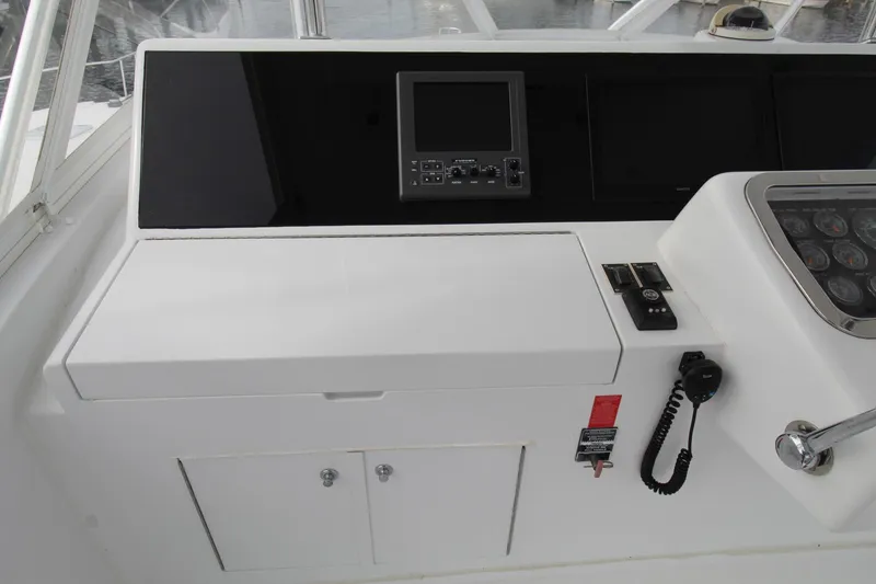 Slide: The Image of Helm station of 2005 Hatteras 50' Convertible yacht with navigation equipment and controls. - 48