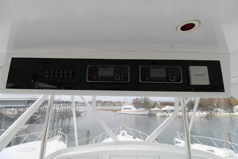 Slide: The Image of Hatteras 50' Convertible 2005 yacht helm with navigation equipment and marina view. - 49