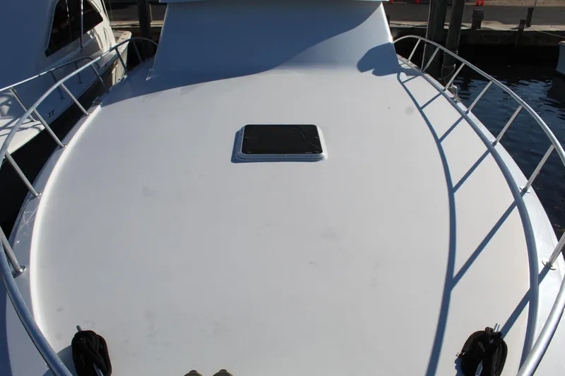 Slide: The Image of 2005 Hatteras 50' Convertible yacht deck with railing and hatch. - 7