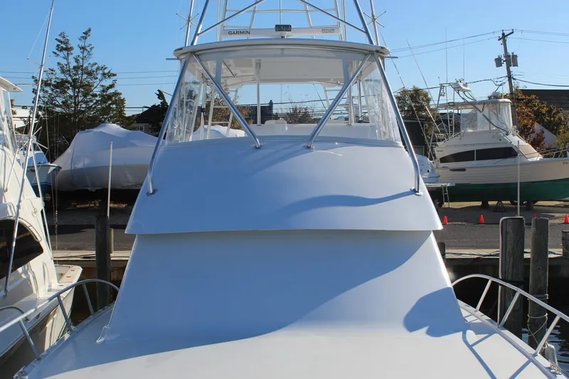 Slide: The Image of 2005 Hatteras 50' Convertible yacht docked at a marina. - 8