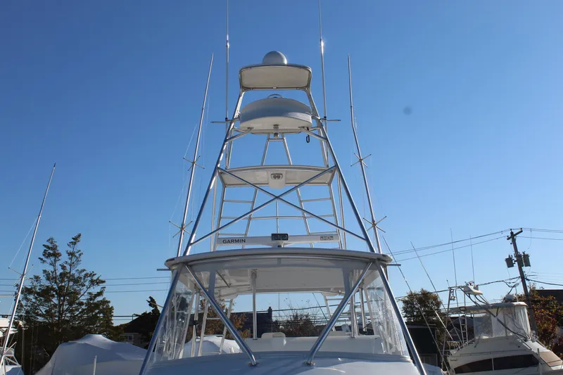 Slide: The Image of 2005 Hatteras 50' Convertible yacht with tower against clear blue sky. - 9
