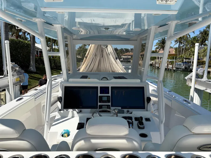 Slide: The Image of Interior view of 2020 Invincible 40 Catamaran with dual screens and modern controls. - 13