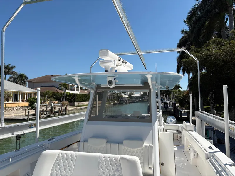 Slide: The Image of 2020 Invincible 40 Catamaran docked, featuring sleek design and advanced navigation equipment. - 17