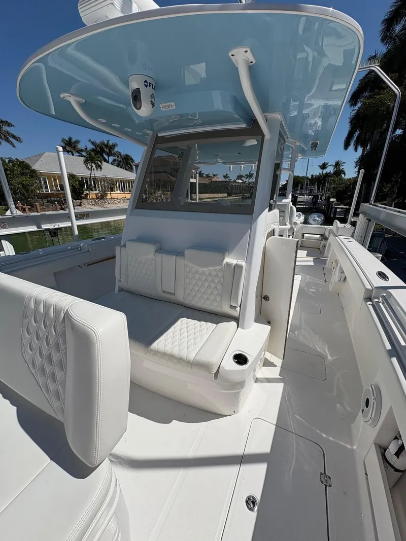 Slide: The Image of 2020 Invincible 40 Catamaran with sleek design and spacious deck in a sunny marina. - 18