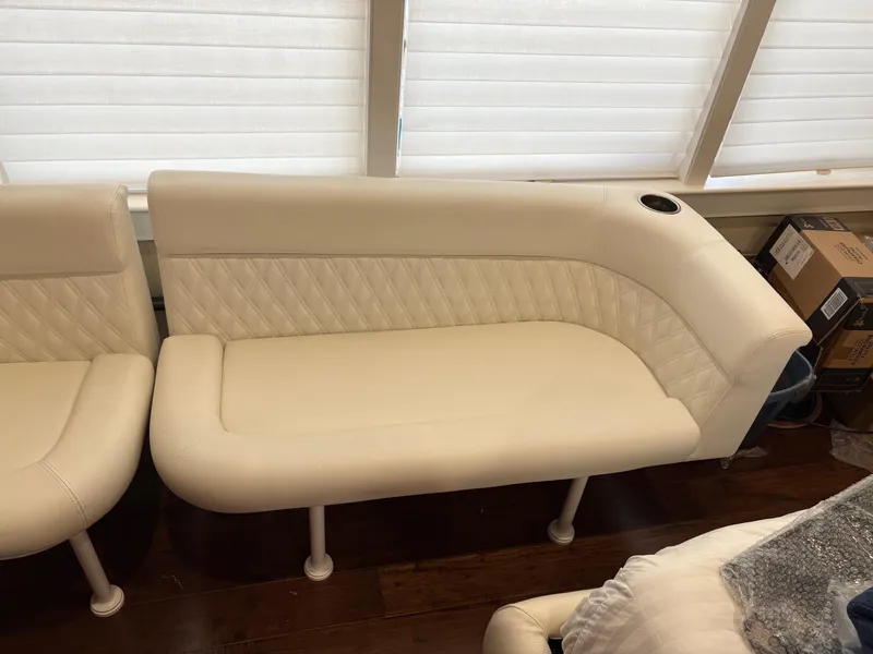 Slide: The Image of White leather seating on 2020 Invincible 40 Catamaran, featuring quilted design and cup holder. - 20
