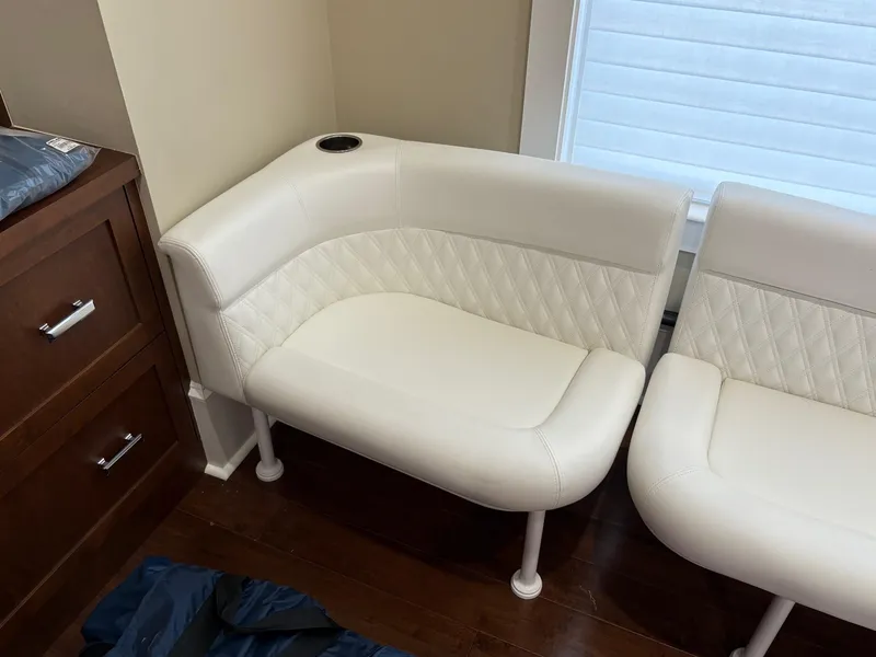 Slide: The Image of White leather seating on 2020 Invincible 40 Catamaran, featuring quilted design and cup holder. - 21