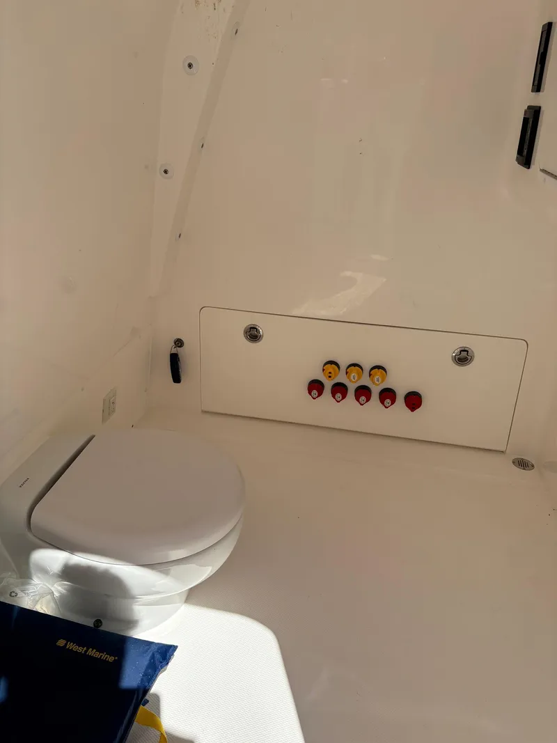 Slide: The Image of 2020 Invincible 40 Catamaran interior with toilet and control panel. - 22