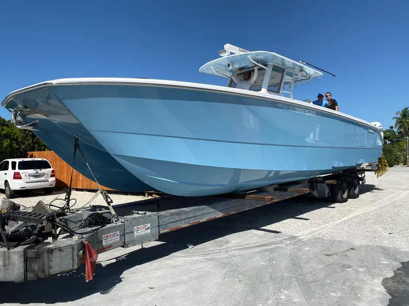 Slide: The Image of 2020 Invincible 40 Catamaran in light blue on trailer, sunny day. - 3