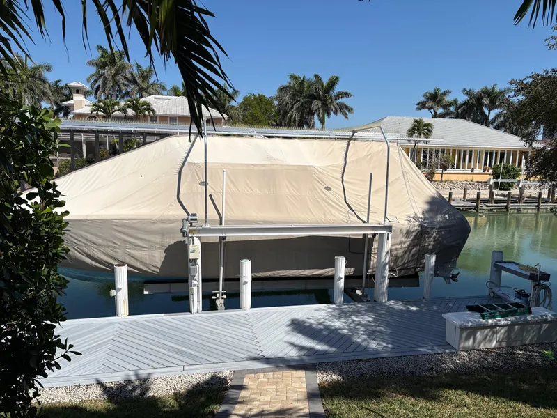 Slide: The Image of Covered 2020 Invincible 40 Catamaran docked in a tropical setting with palm trees. - 5