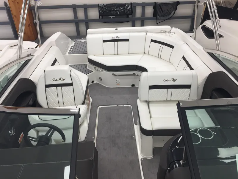 Slide: The Image of 2018 Sea Ray SLX 250 boat interior with white seating and sleek design. - 12