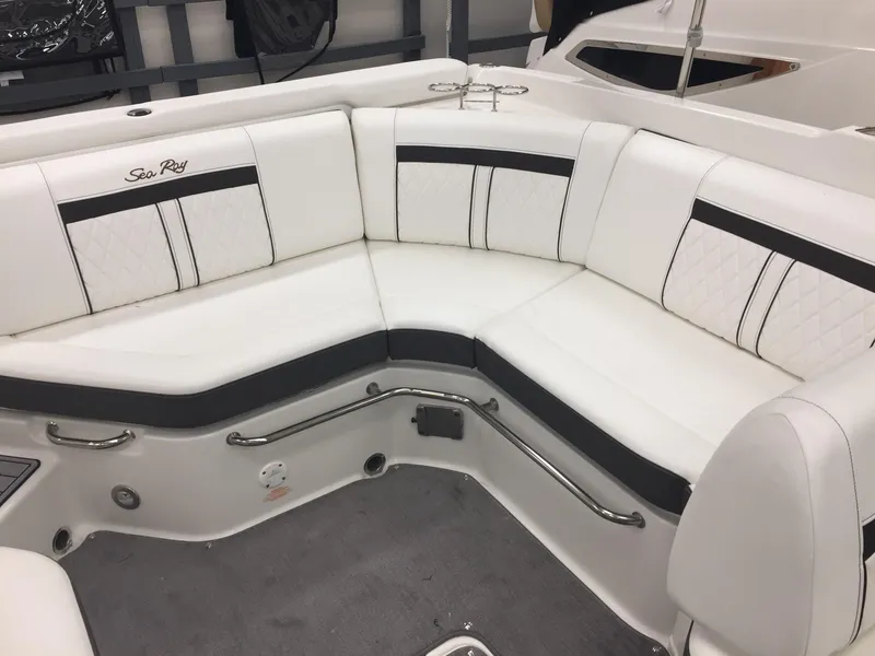 Slide: The Image of 2018 Sea Ray SLX 250 boat interior with white and black seating. - 14